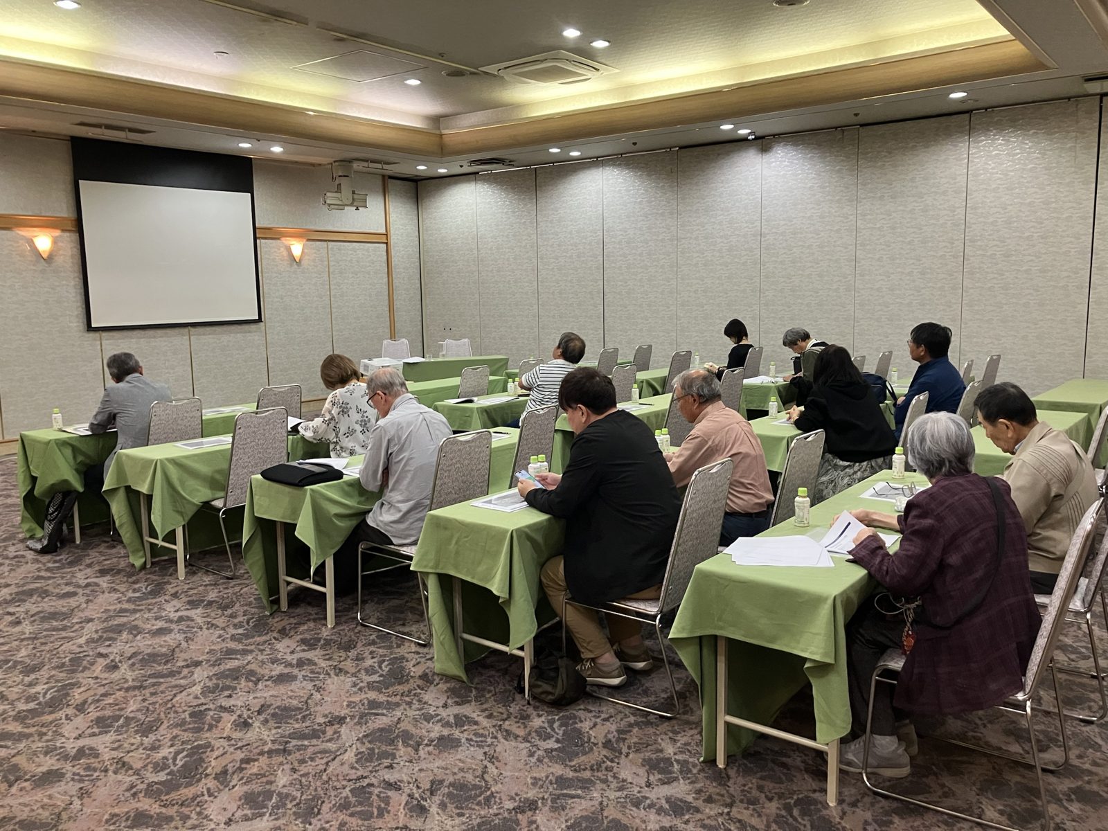 奈良パークホテルで開催したタックス・プラン税理士法人の相続セミナーの会場。資料を手にした参加者の皆様が、財産評価の改正（いわゆる5年ルール）についての講演を聴いている様子。